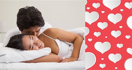 simsearch:400-07483522,k - Couple lying in bed and cuddling against heart pattern Stock Photo - Budget Royalty-Free & Subscription, Code: 400-07936221