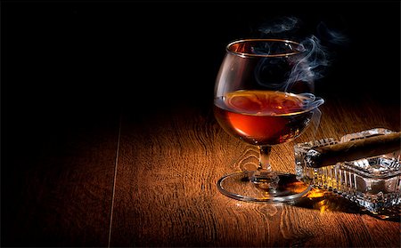 Cognac and cigar on ashtray on a wooden table Stock Photo - Budget Royalty-Free & Subscription, Code: 400-07936317