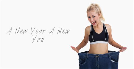 Portrait of young thin woman wearing old pants after losing weight over white background Stock Photo - Budget Royalty-Free & Subscription, Code: 400-07936579