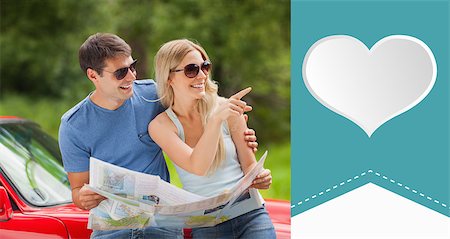 simsearch:400-07058116,k - Cheerful young couple reading map against heart label Stock Photo - Budget Royalty-Free & Subscription, Code: 400-07936615