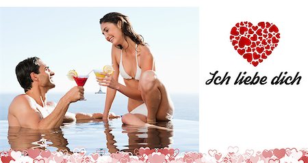 Couple having cocktails in the pool against ich liebe dich Stock Photo - Budget Royalty-Free & Subscription, Code: 400-07936687