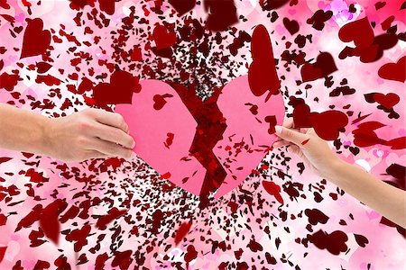 simsearch:400-08980419,k - Hands holding two halves of broken heart against digitally generated girly heart design Stock Photo - Budget Royalty-Free & Subscription, Code: 400-07937218