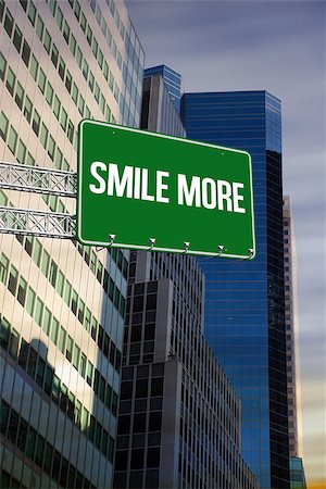 simsearch:400-07525974,k - The word smile more and green billboard sign against low angle view of skyscrapers Stock Photo - Budget Royalty-Free & Subscription, Code: 400-07937360