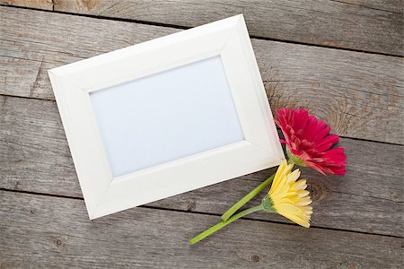 simsearch:400-07662543,k - Two colorful gerbera flowers and photo frame on wooden table Stock Photo - Budget Royalty-Free & Subscription, Code: 400-07937757