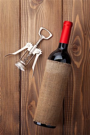 simsearch:400-07933837,k - Red wine bottle and corkscrew on wooden table background. Top view Stockbilder - Microstock & Abonnement, Bildnummer: 400-07937771