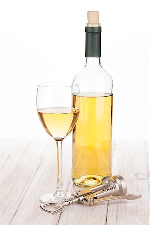 simsearch:400-07937813,k - White wine glass, bottle and corkscrew on white wooden table Photographie de stock - Aubaine LD & Abonnement, Code: 400-07937800