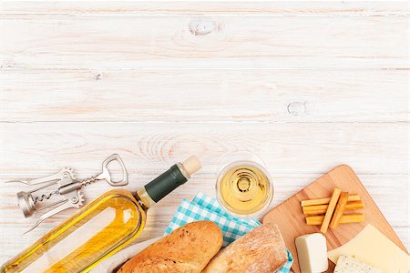 White wine, cheese and bread on white wooden table background with copy space Stock Photo - Budget Royalty-Free & Subscription, Code: 400-07937802