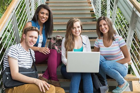 Smiling students sitting on steps with laptop at the university Stock Photo - Budget Royalty-Free & Subscription, Code: 400-07938277