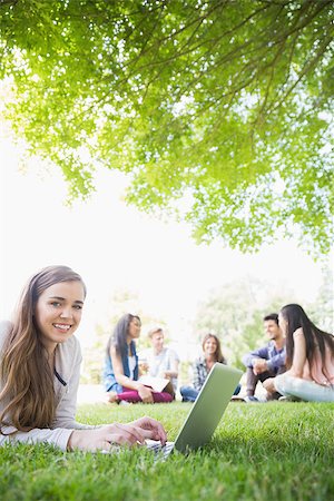 simsearch:400-07939821,k - Happy student using her laptop outside at the university Photographie de stock - Aubaine LD & Abonnement, Code: 400-07938362