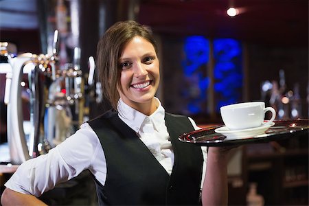 Happy barmaid holding tray with coffee in a bar Stock Photo - Budget Royalty-Free & Subscription, Code: 400-07938424