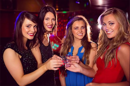 simsearch:400-07939979,k - Pretty friends drinking shots together at the nightclub Fotografie stock - Microstock e Abbonamento, Codice: 400-07938498