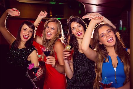 simsearch:649-06844392,k - Pretty friends drinking cocktails together at the nightclub Stock Photo - Budget Royalty-Free & Subscription, Code: 400-07938504