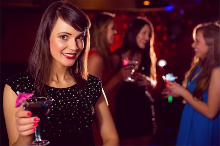 simsearch:400-07939979,k - Pretty brunette drinking a cocktail at the nightclub Fotografie stock - Microstock e Abbonamento, Codice: 400-07938506