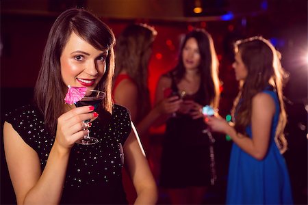 simsearch:649-06844392,k - Pretty brunette drinking a cocktail at the nightclub Stock Photo - Budget Royalty-Free & Subscription, Code: 400-07938507