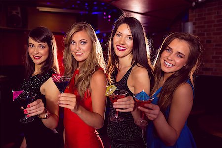 simsearch:400-07939979,k - Pretty friends drinking cocktails together at the nightclub Fotografie stock - Microstock e Abbonamento, Codice: 400-07938503