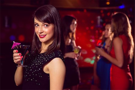 simsearch:649-06844392,k - Pretty brunette drinking a cocktail at the nightclub Stock Photo - Budget Royalty-Free & Subscription, Code: 400-07938513
