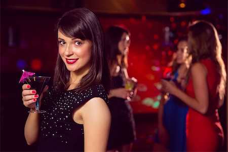 simsearch:400-07939979,k - Pretty brunette drinking a cocktail at the nightclub Fotografie stock - Microstock e Abbonamento, Codice: 400-07938513