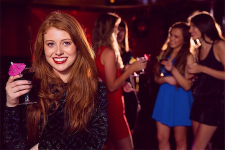 simsearch:400-07939979,k - Pretty redhead drinking a cocktail at the nightclub Fotografie stock - Microstock e Abbonamento, Codice: 400-07938524