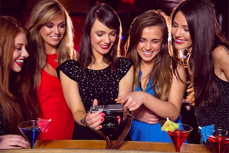 simsearch:400-07939979,k - Pretty friends looking at camera together at the nightclub Fotografie stock - Microstock e Abbonamento, Codice: 400-07938521