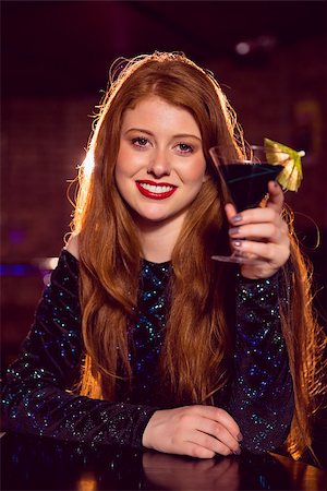 simsearch:400-07939979,k - Pretty redhead drinking a cocktail at the nightclub Fotografie stock - Microstock e Abbonamento, Codice: 400-07938539