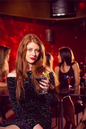 simsearch:649-06844392,k - Pretty redhead drinking a cocktail at the nightclub Stock Photo - Budget Royalty-Free & Subscription, Code: 400-07938549