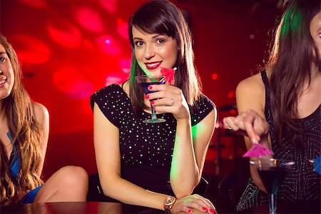 simsearch:400-07939979,k - Pretty brunette drinking a cocktail at the nightclub Fotografie stock - Microstock e Abbonamento, Codice: 400-07938541