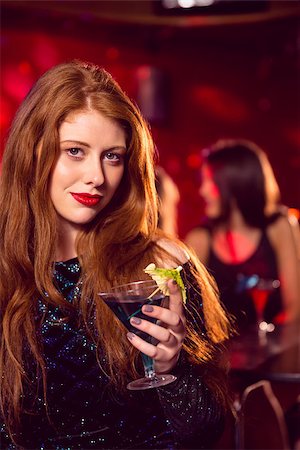 simsearch:649-06844392,k - Pretty redhead drinking a cocktail at the nightclub Stock Photo - Budget Royalty-Free & Subscription, Code: 400-07938550