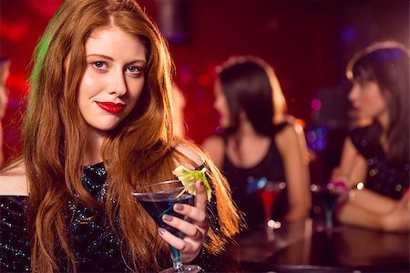 simsearch:400-07939979,k - Pretty redhead drinking a cocktail at the nightclub Fotografie stock - Microstock e Abbonamento, Codice: 400-07938551