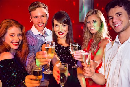 simsearch:400-07939979,k - Happy friends on a night out together at the nightclub Fotografie stock - Microstock e Abbonamento, Codice: 400-07938579