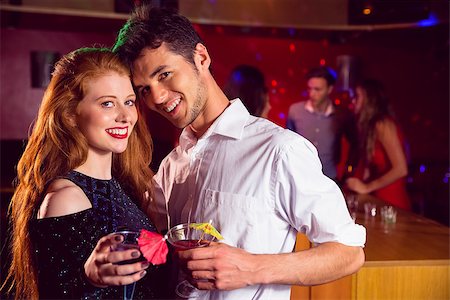 simsearch:649-06844392,k - Cute couple drinking cocktails together at the nightclub Stock Photo - Budget Royalty-Free & Subscription, Code: 400-07938572