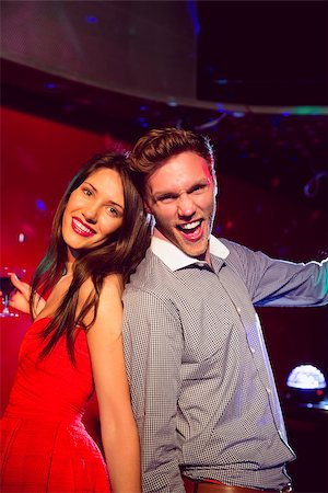 simsearch:400-07939979,k - Happy friends dancing and smiling at the nightclub Fotografie stock - Microstock e Abbonamento, Codice: 400-07938583