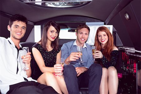 Happy friends drinking champagne in limousine on a night out Stock Photo - Budget Royalty-Free & Subscription, Code: 400-07938623