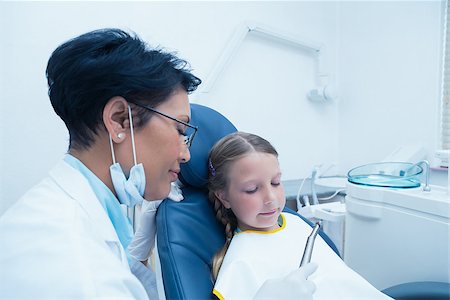 simsearch:400-07938824,k - Female dentist examining girls teeth in the dentists chair Foto de stock - Super Valor sin royalties y Suscripción, Código: 400-07938695