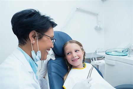 simsearch:400-07938824,k - Female dentist examining girls teeth in the dentists chair Foto de stock - Super Valor sin royalties y Suscripción, Código: 400-07938696