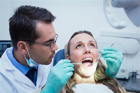 simsearch:400-07938964,k - Dentist examining young womans teeth in the dentists chair Stockbilder - Microstock & Abonnement, Bildnummer: 400-07938790