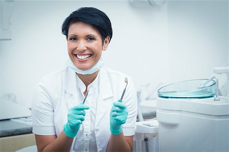 female with dental tools at work - Portrait of happy confident female dentist holding dental tools Stock Photo - Budget Royalty-Free & Subscription, Code: 400-07938807