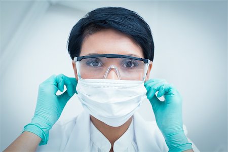 simsearch:400-07941465,k - Portrait of female dentist wearing surgical mask and safety glasses Stock Photo - Budget Royalty-Free & Subscription, Code: 400-07938814