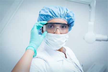 simsearch:400-07941465,k - Portrait of female dentist wearing surgical mask and safety glasses Stock Photo - Budget Royalty-Free & Subscription, Code: 400-07938820