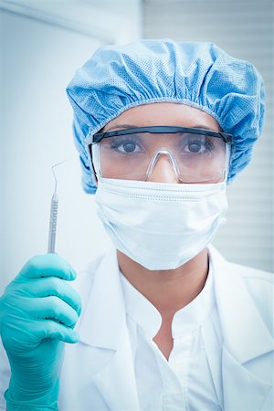 simsearch:400-07941465,k - Portrait of female dentist wearing surgical mask and safety glasses Stock Photo - Budget Royalty-Free & Subscription, Code: 400-07938822