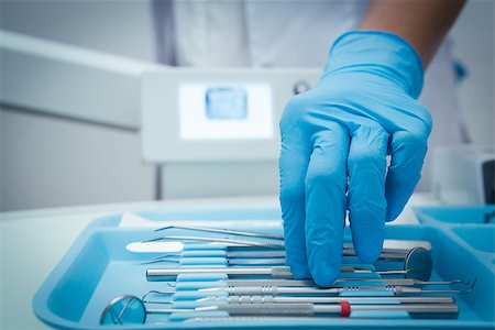 dentistry tray - Close up of gloved hand picking dental tools Stock Photo - Budget Royalty-Free & Subscription, Code: 400-07938839