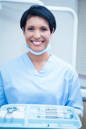 dentist tray - Portrait of female dentist in blue scrubs holding tray of tools Stock Photo - Budget Royalty-Free & Subscription, Code: 400-07938912