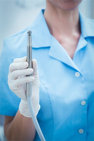 simsearch:400-07941454,k - Close up mid section of female dentist holding dental drill Stockbilder - Microstock & Abonnement, Bildnummer: 400-07938966