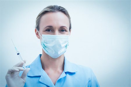 simsearch:400-07941465,k - Portrait of young female dentist in surgical mask holding injection Stock Photo - Budget Royalty-Free & Subscription, Code: 400-07938970
