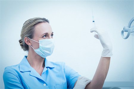 simsearch:400-07941454,k - Concentrated female dentist in surgical mask holding injection Stockbilder - Microstock & Abonnement, Bildnummer: 400-07938972