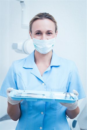 simsearch:400-07938947,k - Portrait of female dentist in surgical mask holding tray of tools Photographie de stock - Aubaine LD & Abonnement, Code: 400-07938987