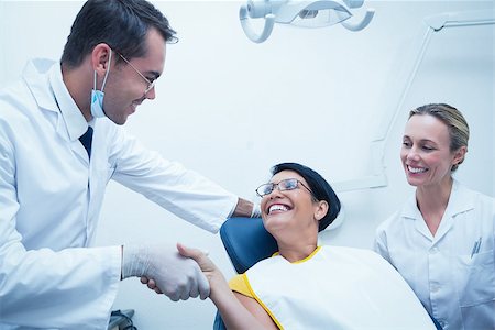 pictures of two nurses shaking hands - Male dentist shaking hands with woman in the dentists chair Stock Photo - Budget Royalty-Free & Subscription, Code: 400-07939029