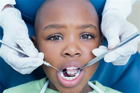 surgical gloves boys - Close up of boy having his teeth examined by a dentist Stock Photo - Budget Royalty-Free & Subscription, Code: 400-07939082