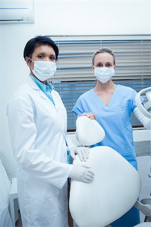 dentist and dental assistant relationship - Portrait of two female dentists wearing surgical masks Stock Photo - Budget Royalty-Free & Subscription, Code: 400-07939097