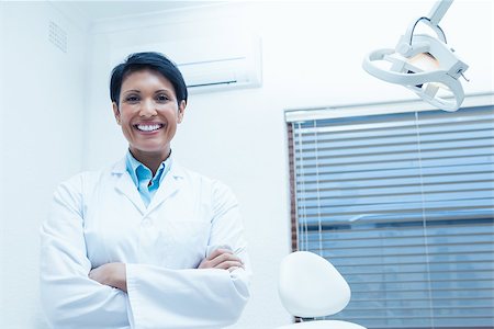 dental work - Portrait of smiling female dentist standing with arms crossed Stock Photo - Budget Royalty-Free & Subscription, Code: 400-07939104