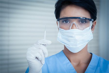 simsearch:400-07941465,k - Portrait of female dentist in surgical mask holding dental tool Stock Photo - Budget Royalty-Free & Subscription, Code: 400-07939166